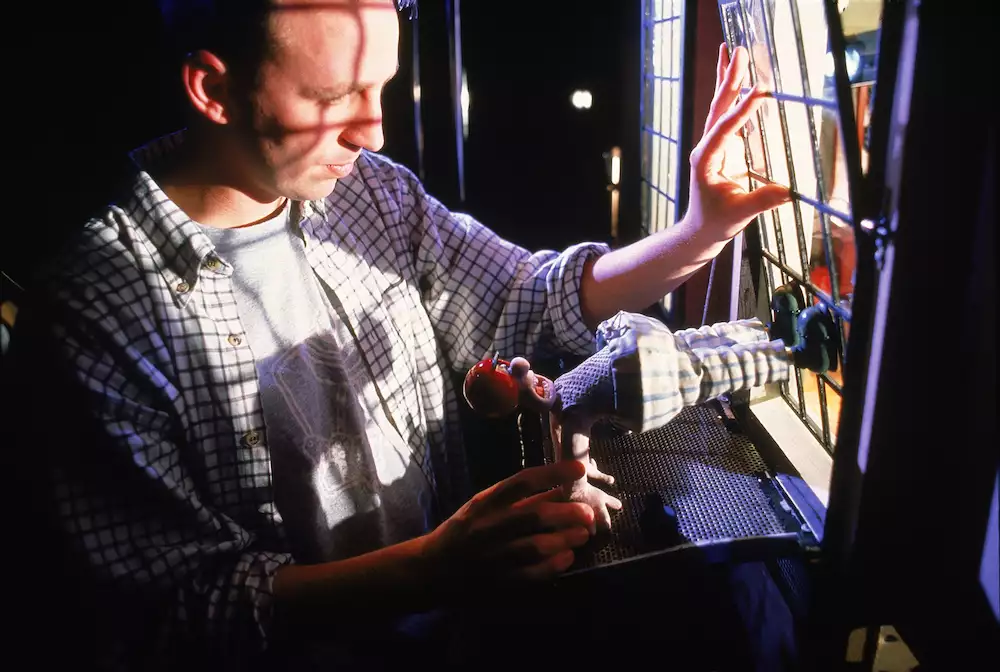 An animator at Aardman creating a scene