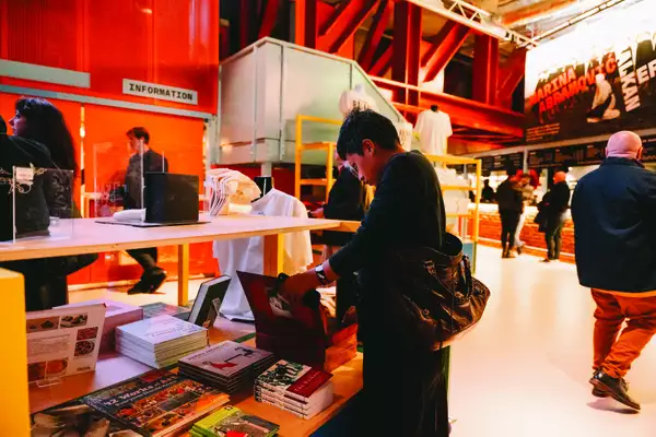 A person looking at books in the shop at Aviva Studios