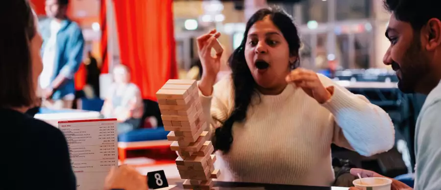 Someone playing Jenga – the tower is mid-falling