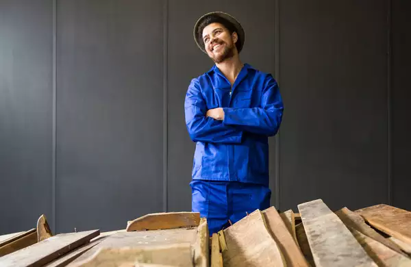 Photographic portrait of Kemang wa Lehulere, stood behind planks of wood