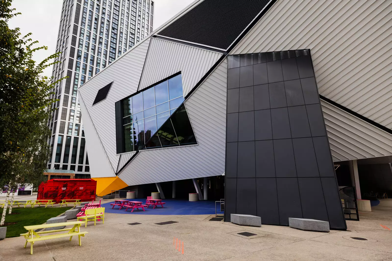Aviva Studios viewed from River Square, with a tower block in the background