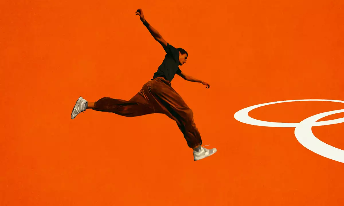 A person jumping on a bright orange background