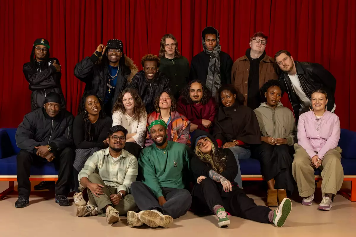 Group photo of the Factory Sounds 2026 cohort in front of a red curtain