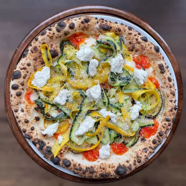 Pizza from Honest Crust with vegetables and cheese on