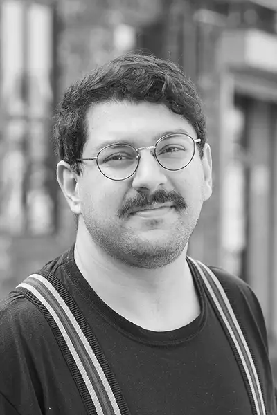 Black and white headshot of Parham Ghalamdar smiling