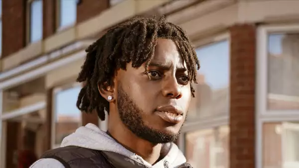 Rootz walking down a suburban street looking to the side