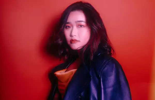 Portrait of Edane against a red background