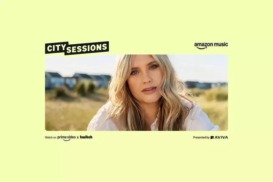 A promotional photograph of the singer Ella Henderson with Amazon and Aviva branding on a yellow background