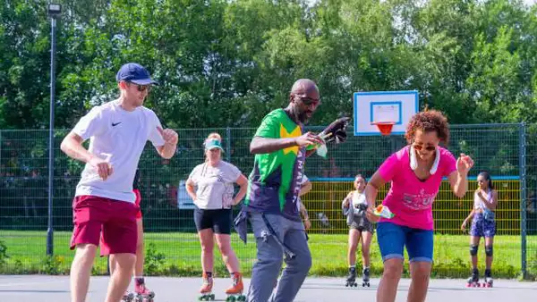 Three people on roller-skates outside