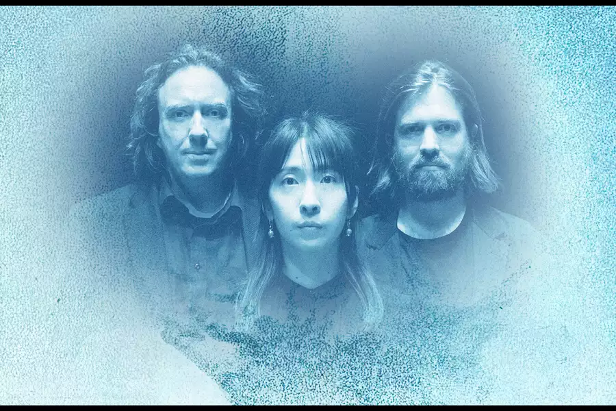 Thorsten Quaeschning, Hoshiko Yamane and Paul Frick on a gradient blue-toned background, which resembles the album cover for Phaedra.