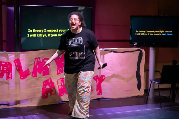 A performer shouting on stage at Balmy Army: A Contact Takeover