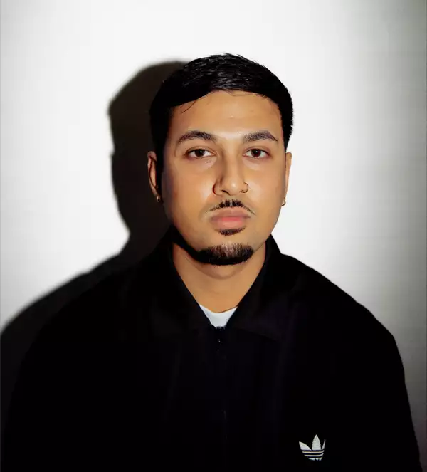 Hriday Das wearing a black Adidas zipped jumper on a white background