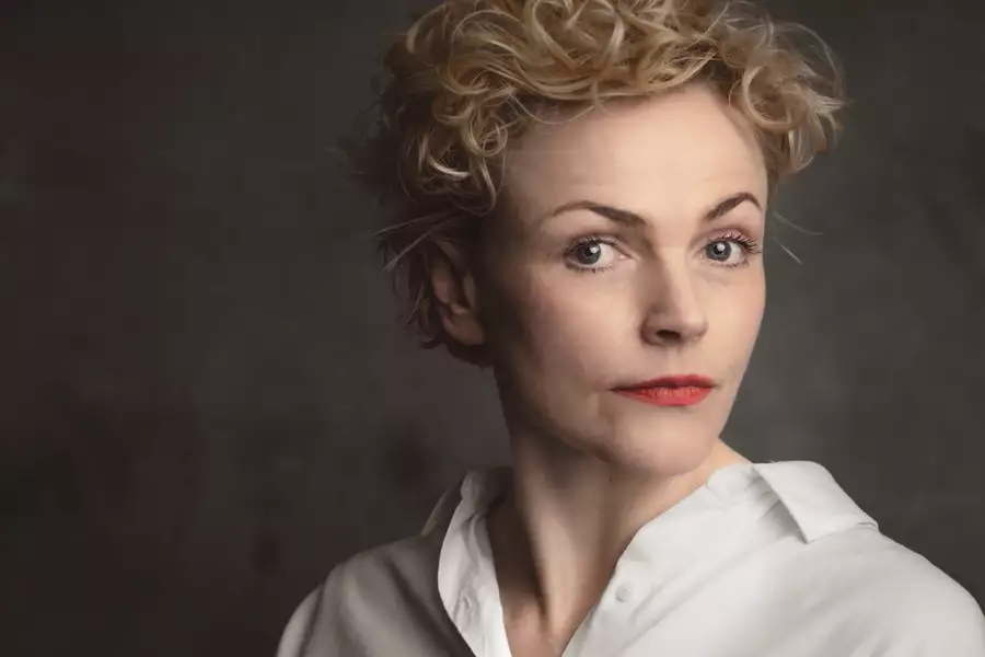 A headshot of the actor Maxine Peake wearing a white shirt