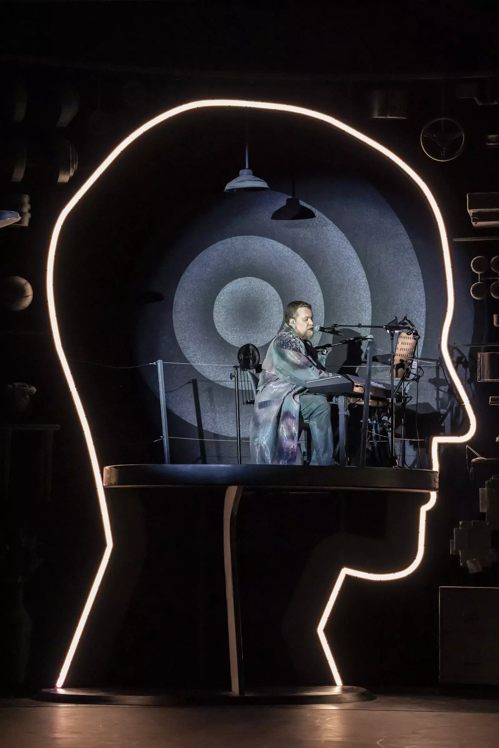 A photo of singer/musician John Grant in a structure shaped like the outline of a human head