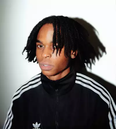 Anthony Namba wearing a black Adidas tracksuit top on a white background