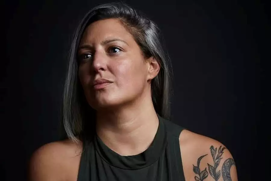 Headshot of Chimene Suleyman on a black background