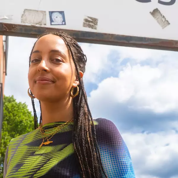 Stefanie Reynolds stood outside underneath a road sign
