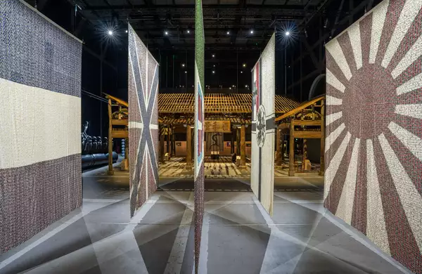 Five flags from the Eight-Nation Alliance Flags on display in the exhibition, with the Wang Family Ancestral Hall visible behind