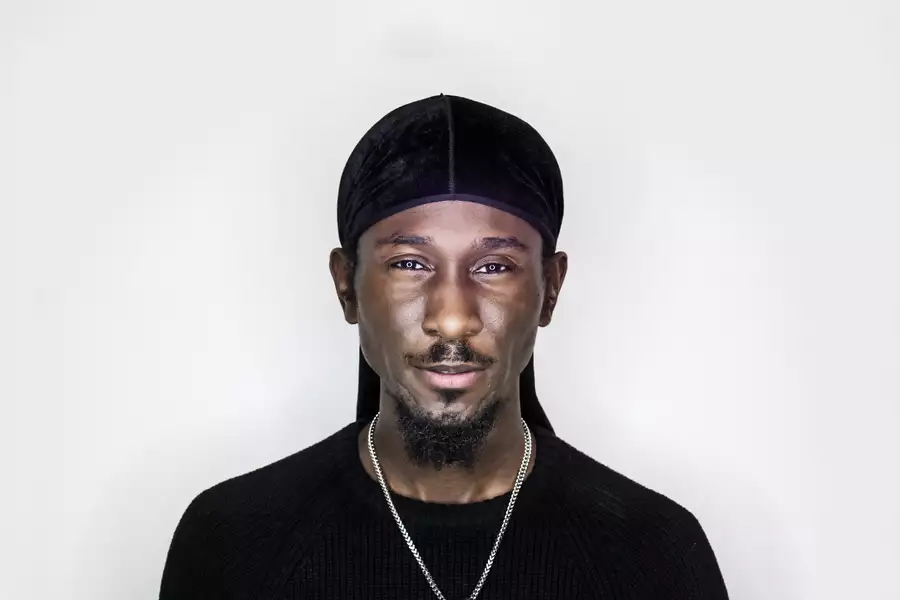 Portrait of Cephas Williams wearing black on a white background