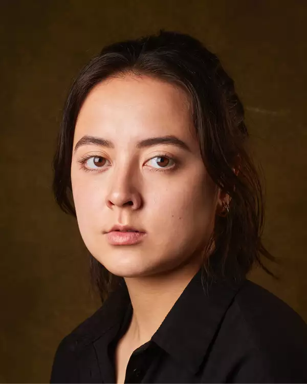 Headshot of Ami Tredrea wearing a black shirt