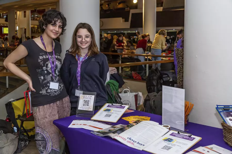 Two people smiling stood next to a stall at the WOW Marketplace