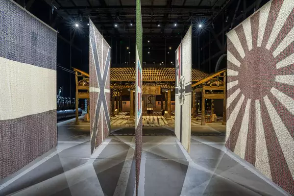 Five flags from the Eight-Nation Alliance Flags on display in the exhibition, with the Wang Family Ancestral Hall visible behind