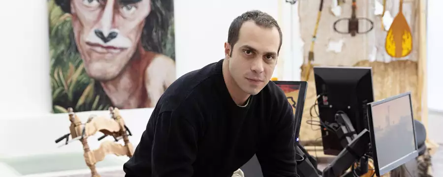 Headshot of Theo Triantafyllidis sitting in an artist studio