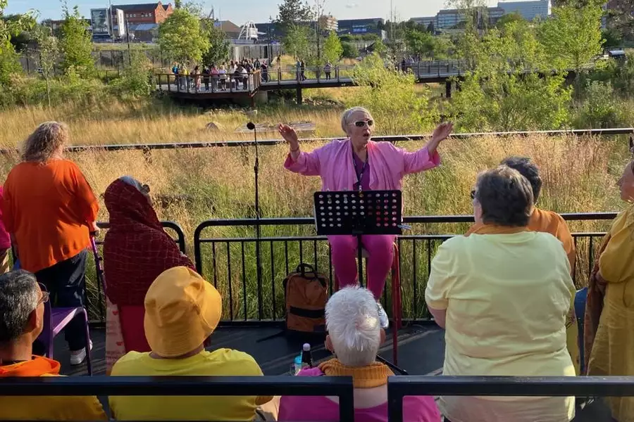 RAMshackle Wailers performing outside on a sunny day, wearing bright clothing