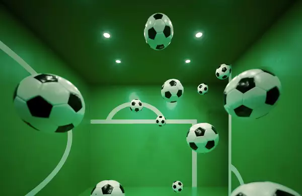 Multiple floating soccer balls inside a green room with white goalpost markings on the walls. The perspective and reflections create an illusion of depth, making it appear as if the balls are suspended in mid-air.