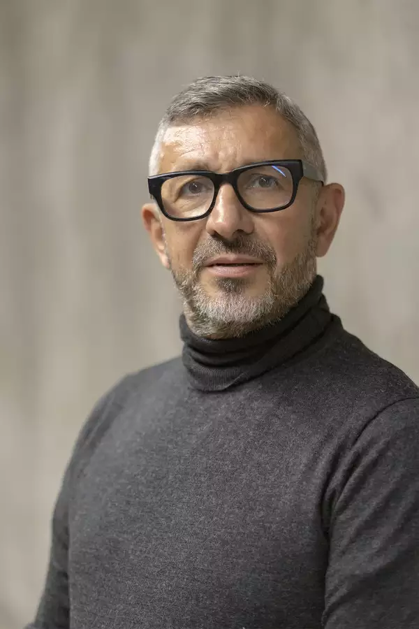 Portrait Photograph of Chris Yianni wearing a grey turtleneck top