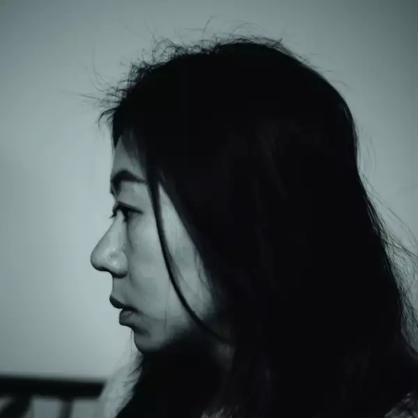 Black and white headshot of Rita Hui