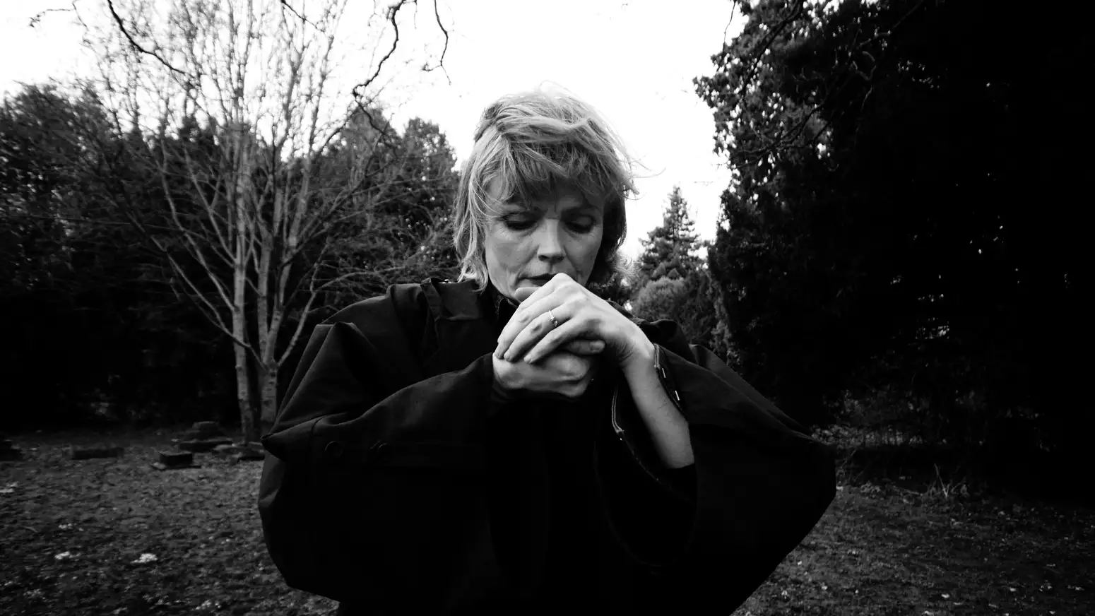 black and white photo of Maxine Peake looking at her hands