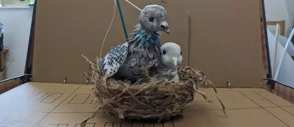 A puppet bird sitting in a nest