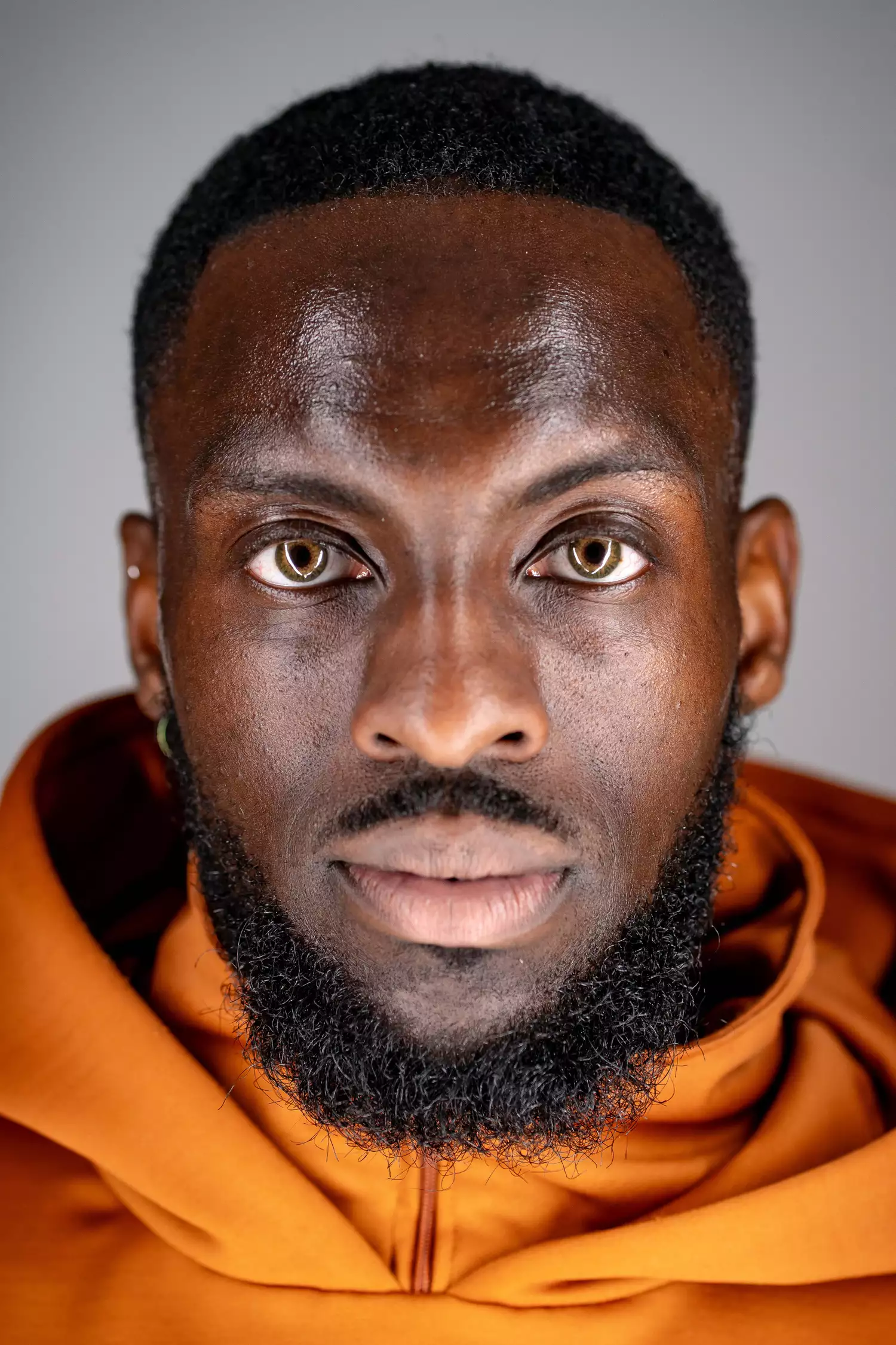 Headshot of Chad Taylor wearing an orange jumper looking at the camera