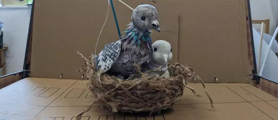 A puppet bird sitting in a nest
