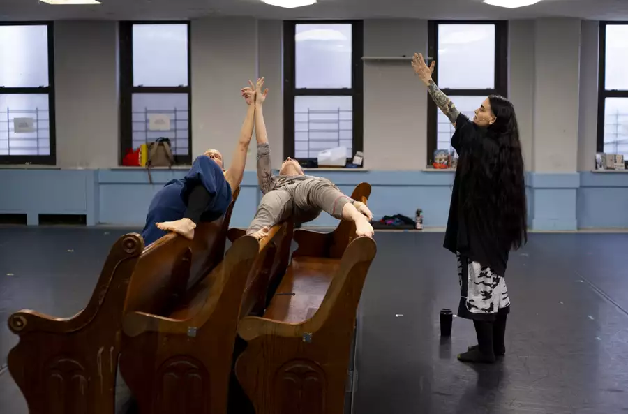 Sonya Tayeh directing two dancers during rehearsals for The Surge. They are performing on a pew.