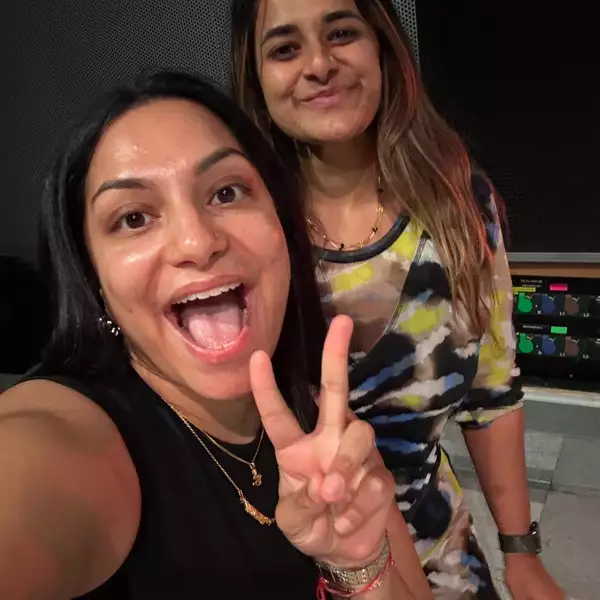afshan d’souza-lodhi and Gitika Buttoo taking a selfie, smiling and pulling a peace sign