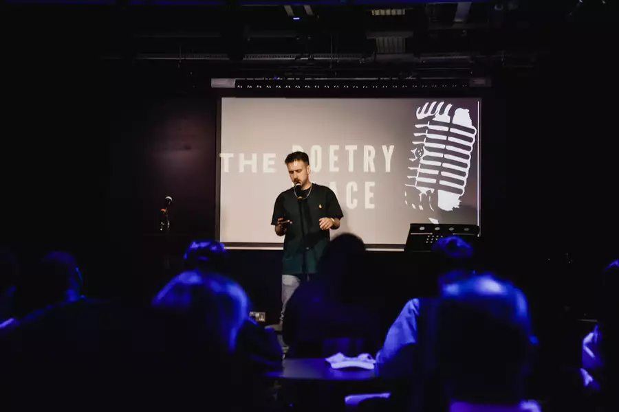 Photo of a poetry slam event with a poet on stage