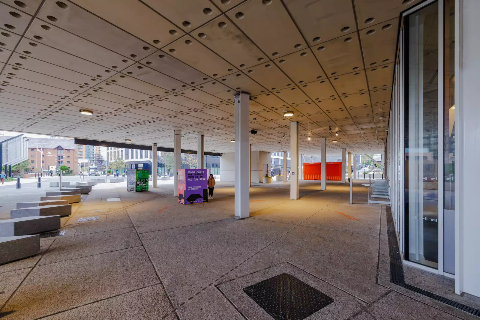 The City Square entrance to Aviva Studios showing concrete floor, pillars and bollards