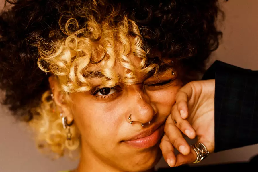 Nxdia pulls a face at the camera wearing a green top