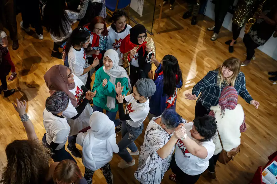 A group of people dancing and clapping
