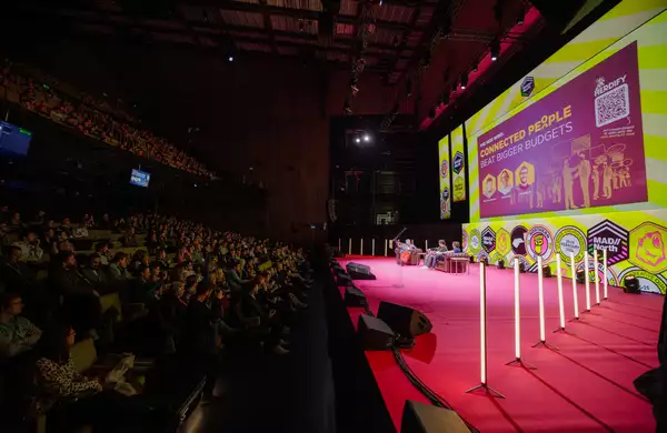 A large audience in the Hall watching a presentation on the stage