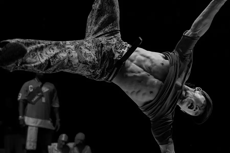 A breakdancer performs a dynamic move