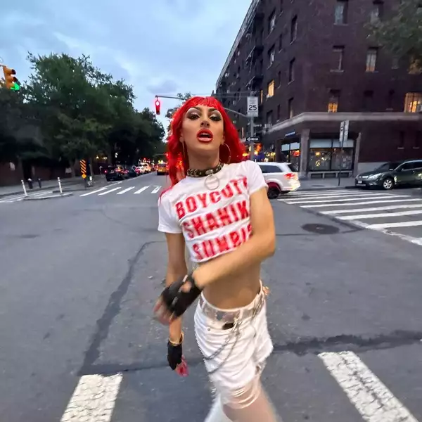 Shanika Sunrise posing on a street outside at dusk