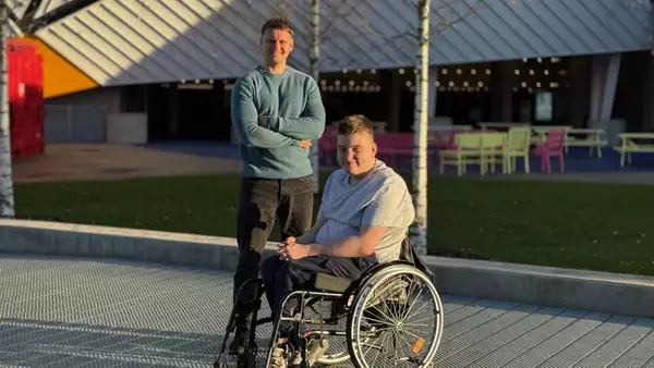 Beck and Jimmy Royals outside Aviva Studios on a sunny day