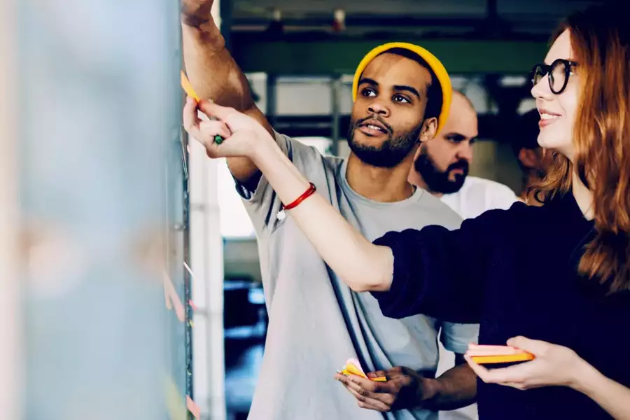 students working together, pointing at board