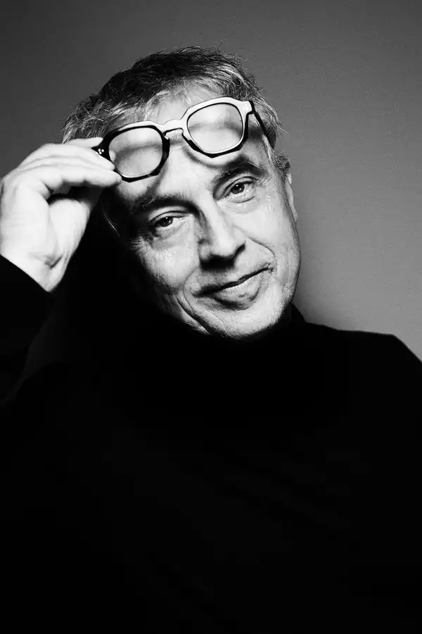 Black and white headshot of Stefano Boeri lifting his glasses away from his eyes