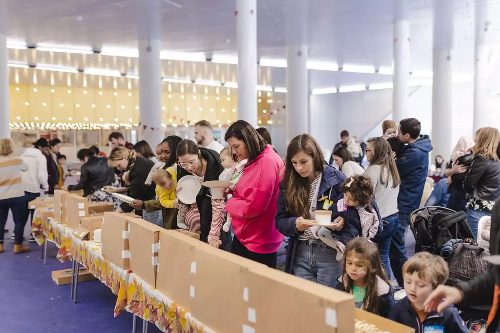 First breath families outside Aviva Studios holding paper plates