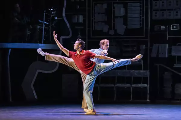 A photo of two ballerinas doing arabesques