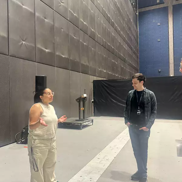 Gitika Buttoo speaking to two other people in the Warehouse